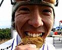 (Click for larger image) Can I eat it? Keiichi Tsujiura (Bridgestone-Anchor) bites his gold medal