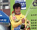 (Click for larger image) Race leader Kin San Wu sprays the Champagne