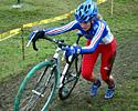 (Click for larger image) Aline Parsy (Fra) pushes her bike up the hill