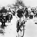(Click for larger image) On Stage 21 of the 1958 Tour,  Charly Gaul launched an audacious solo move on the Luitel, seen here at the crest of the fog-covered Col de Porte with an advantage of five and a half minutes over the chasing bunch. Riding downhill in freezing rain, the Luxembourg rider went on to win the stage in Aix-les-Bains.