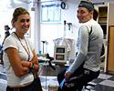 (Click for larger image) Ergo-time. Alexis Rhodes (left) talks to Louise Yaxley, who was spinning her legs over on a stationary bike. Rhodes is now back out on the road and will be racing again next month.
