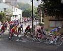 (Click for larger image) The peloton speeds  down the hill.