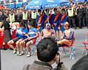 (Click for larger image) Riders wait for the podium ceremony after stage 2. Joe Papp and Derek Wong are seated to the right.
