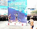 (Click for larger image) Champagne fight on the podium after stage 2: Joe Papp (left) and Derek Wong (right) of Champion System ganged up on stage winner Wong Kam Po.