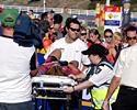 (Click for larger image) Ambulance officers carry Rademaker before taking her to Geelong Hospital