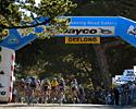 (Click for larger image) The field in the women's criterium make their way under the banner in the Geelong Botanical Gardens