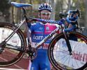 (Click for larger image) Enrico Franzoi (Lampre) carries his bike across the line