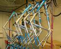 (Click for larger image) Rack O' Rigs:  A raft of Discovery Channel's '06 Trek Madone SL frames in prep phase, prior to team delivery for their first training camp in Solvang, California.