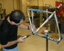 (Click for larger image) Trek's Mark Andrews drills a drain hole  in Discovery Channel's '06 Trek Madone SL frame.