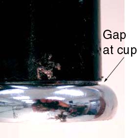 Inspect cup where it enters frame for full seating